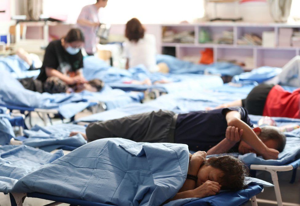 residents rest at a temporary shelter in Longquan Primary School of Mentougou district on August 1, 2023 in Beijing, China.