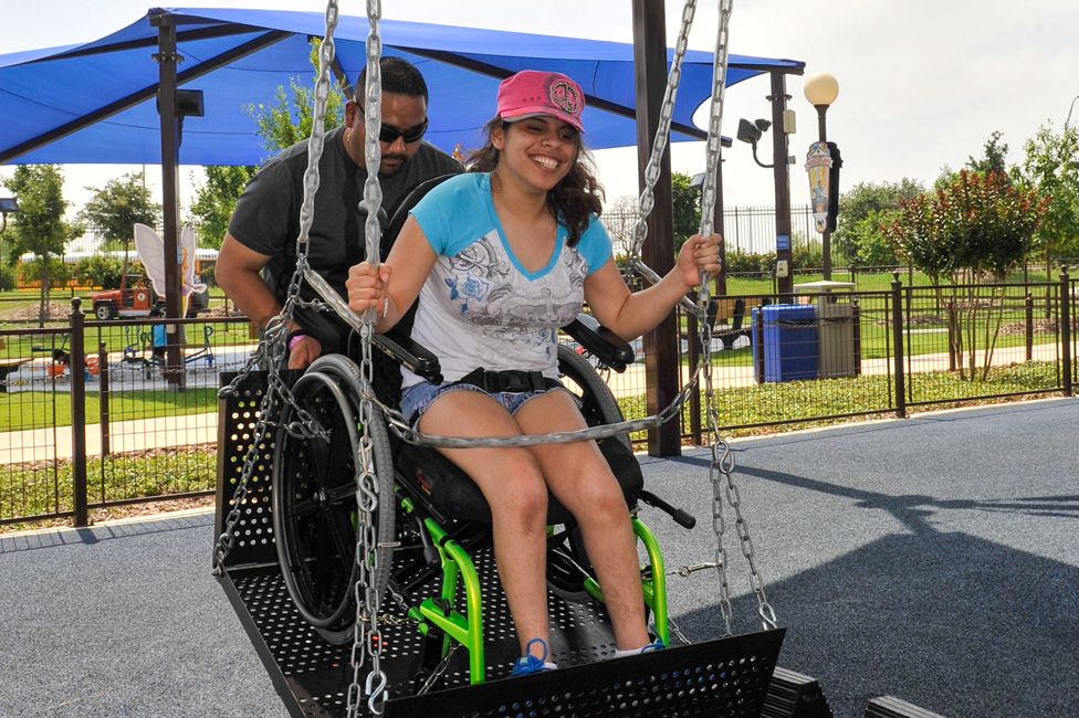 A visitor in a wheel chair swing
