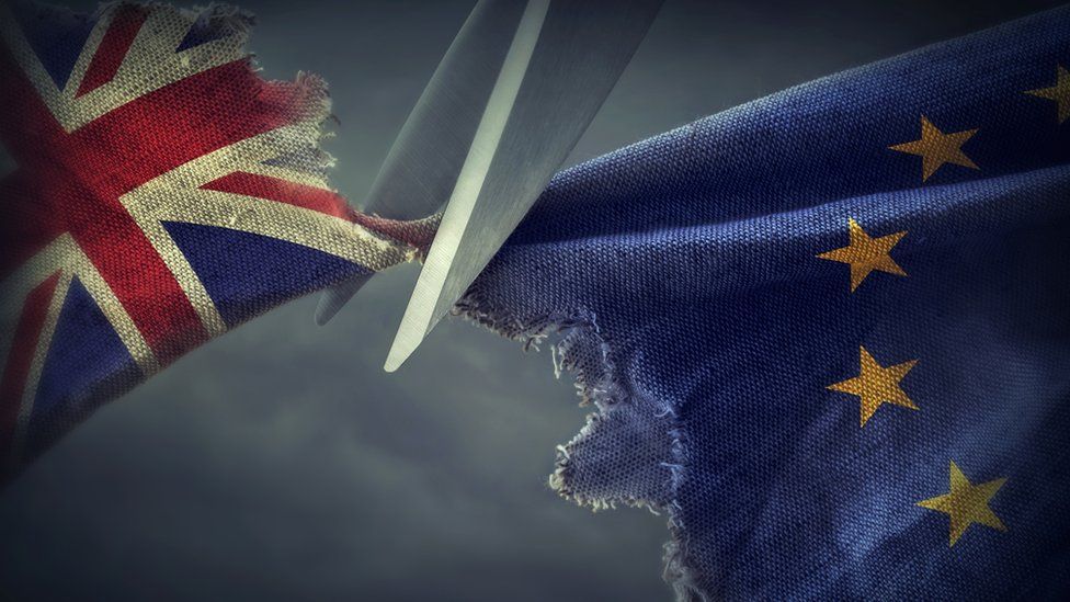 Scissors cutting the British flag from the EU flag