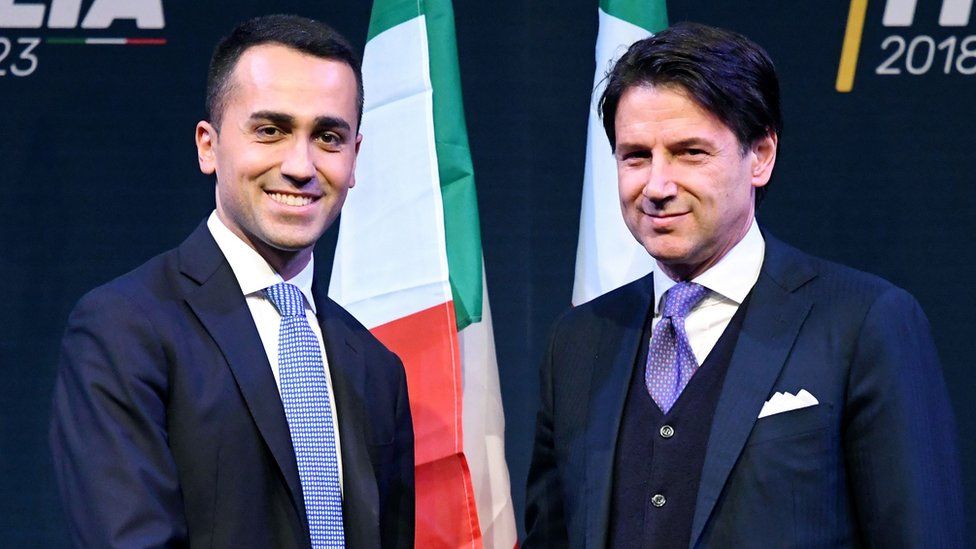 Leader of the Italy's populist Five Star Movement, Luigi Di Maio (L), shakes hands with Italian lawyer Giuseppe Conte, 1 March 2018