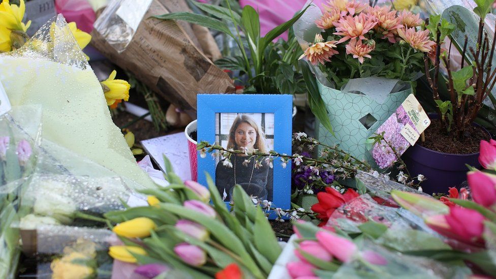 Flowers laid around a photo of Sarah Everard at Clapham Common bandstand in March 2021