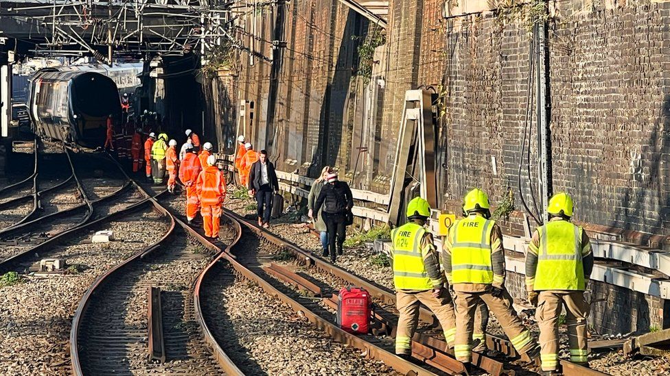 Fire crews and engineers assess the damage on the Euston tracks