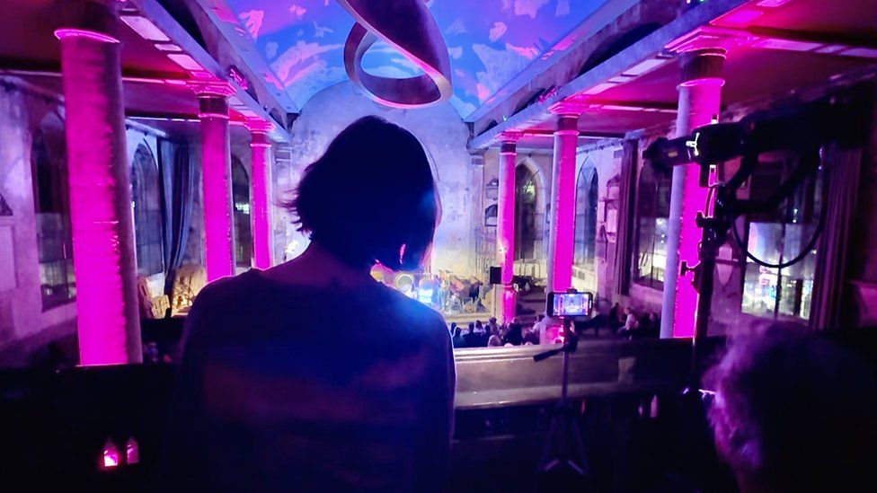 A woman and man seen from behind as they watch a live performance in Bristol