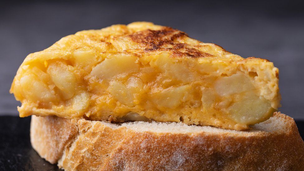 A slice of Spanish tortilla on a piece of bread