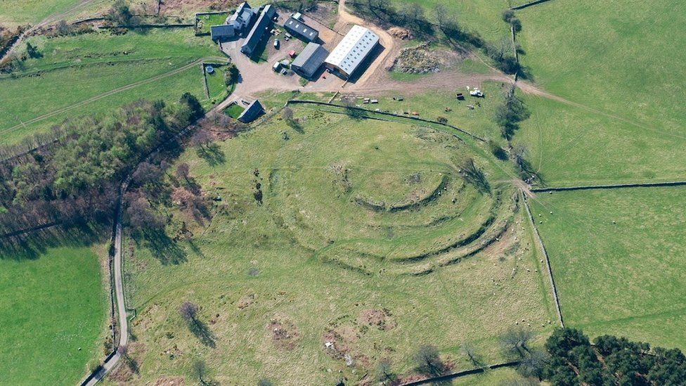 Aerial view of hill fort remains next to modern farm