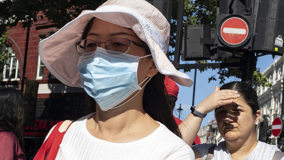 File image of a woman wearing an anti-pollution mask in London
