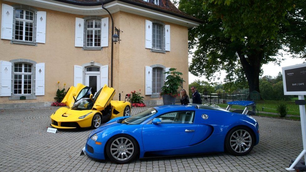 Luxury cars are displayed at an auction in the Swiss village of Cheserex, near Geneva