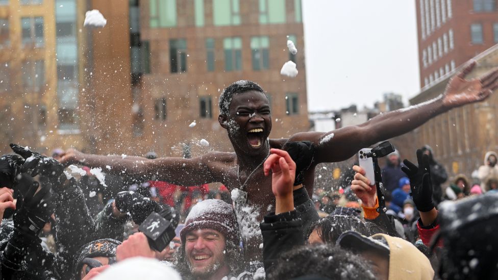 A shirtless Senegalese man taking part in a snowball fight in the US city of New York - Saturday 29 January 2022