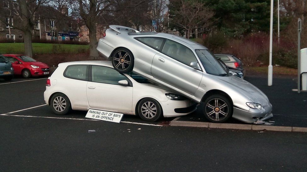 Car parked on top of another one