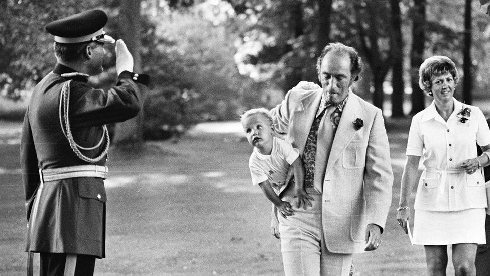 A young Justin Trudeau rests on his father's hip, 1973