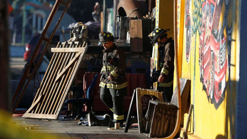 Firefighters exit a warehouse where a fire broke out during an electronic dance party late Friday evening, resulting in at least nine deaths and many unaccounted for in the Fruitvale district of Oakland, California, U.S. December 3, 2016.