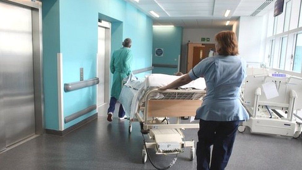 Nurses pushing a bed in an hospital