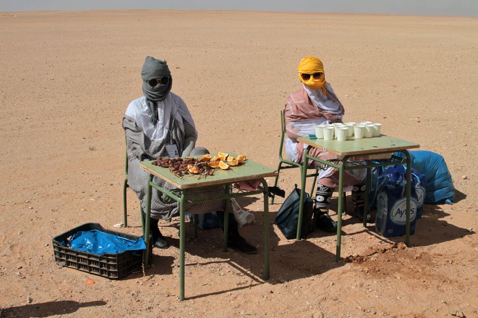 Women at a drinking station in the desert