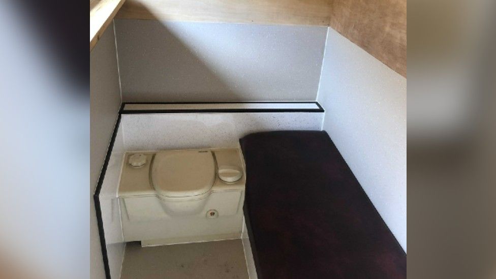 Inside of the pod with a bed and toilet
