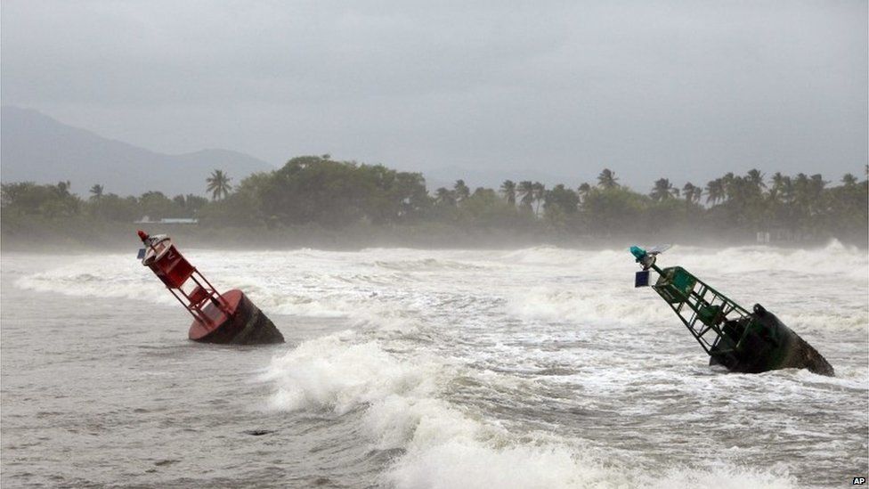 Two large navigation buoys hit by strong winds and waves, float near the coast, as Tropical Storm Erika moves away from the area in Guayama, Puerto Rico