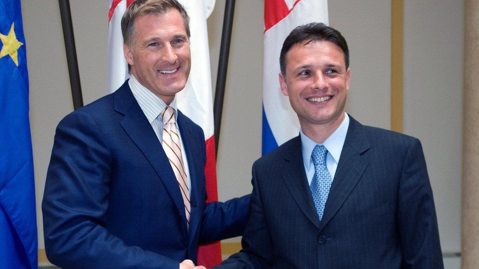 Maxime Bernier (L) shakes hands with his Croatian counterpart Goran Jandrokovic before their meeting in Zagreb