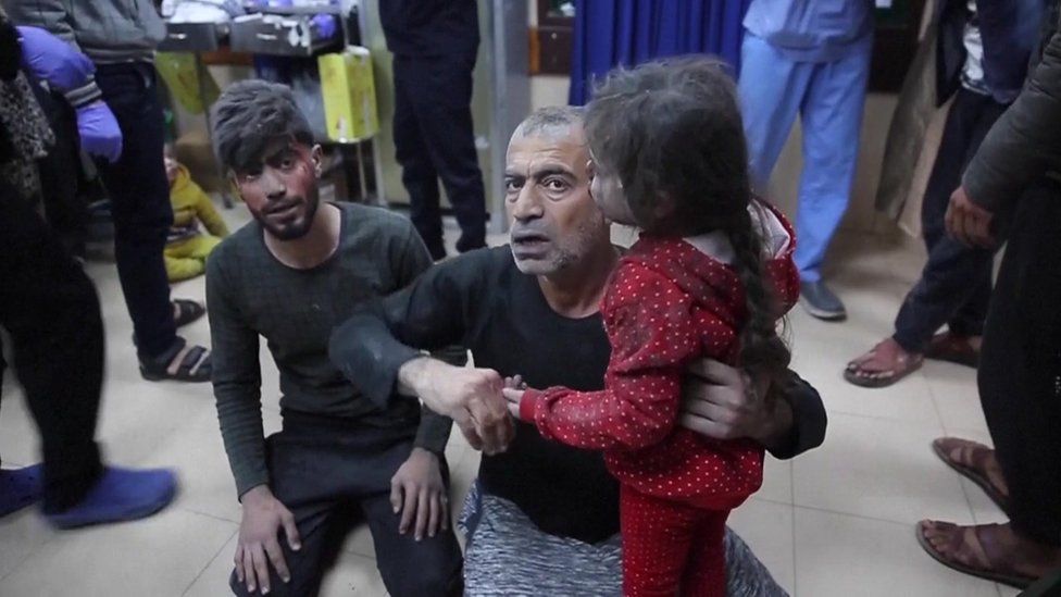 People in Al-Aqsa Hospital after the reported air strike