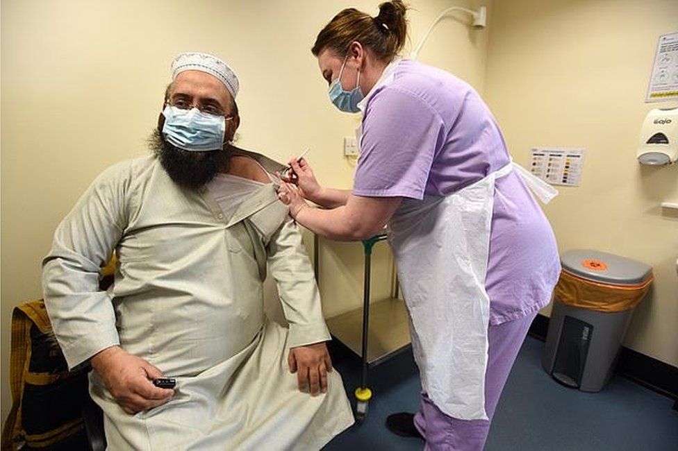 Mufti Zubair Bult receives the vaccine at Whetley medical centre in Bradford