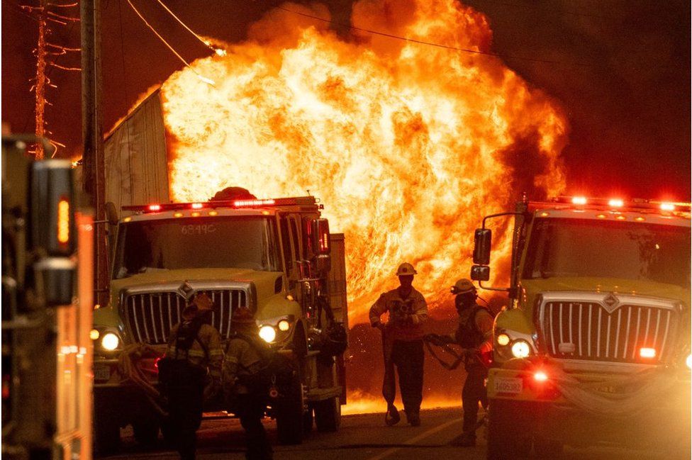A fireball is seen near firefighters