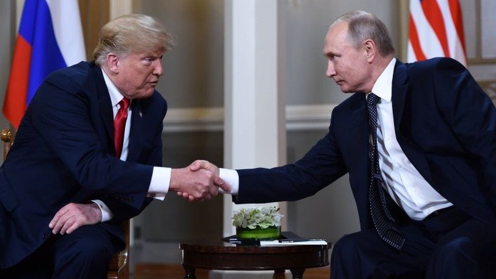 Donald Trump and Vladimir Putin shake hands