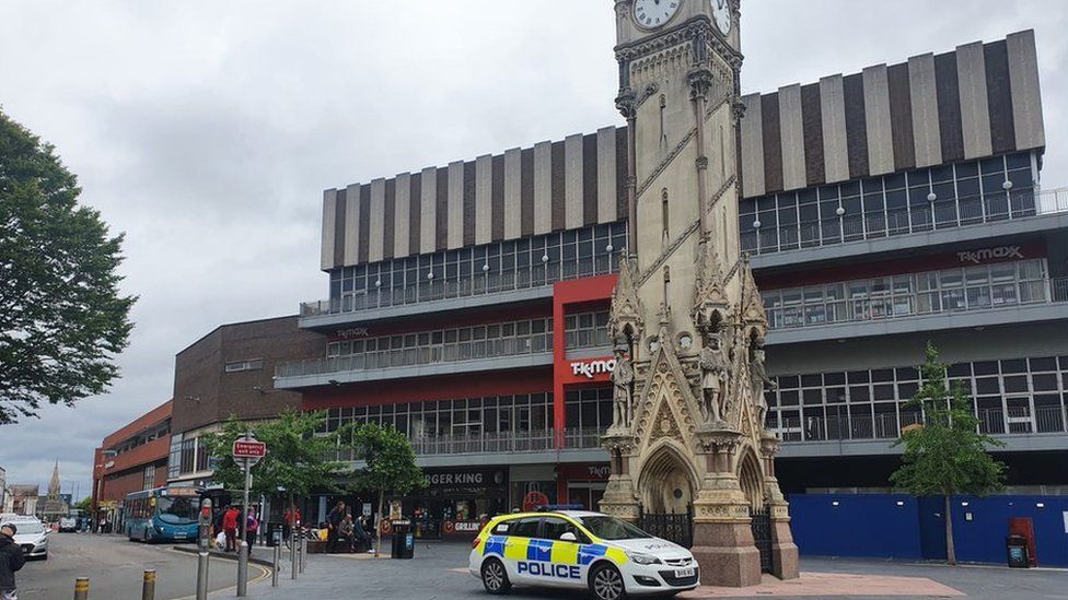 Police next to the city's clock tower