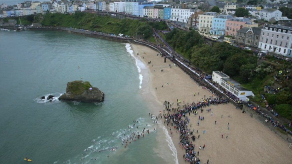 Ironman Wales competitors on Tenby beach