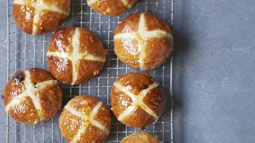 Hot cross buns on a baking tray
