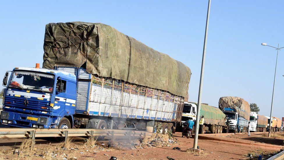 Trucks loaded with goods wait to cross the border in Cinkasse, the northern Togo commercial border post with Burkina Faso, on February 16, 2020