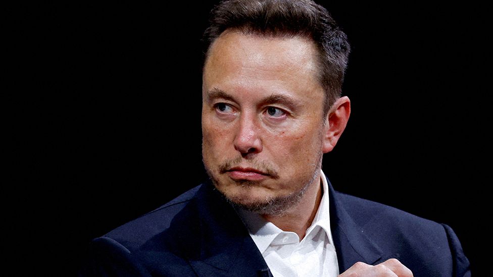 Elon Musk headshot in suit, taken in Paris in June 2023