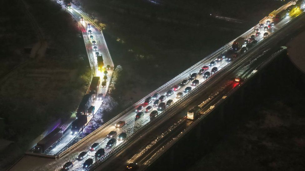 Cars are stuck on a highway due to heavy snow in Wuhan, in central China's Hubei province