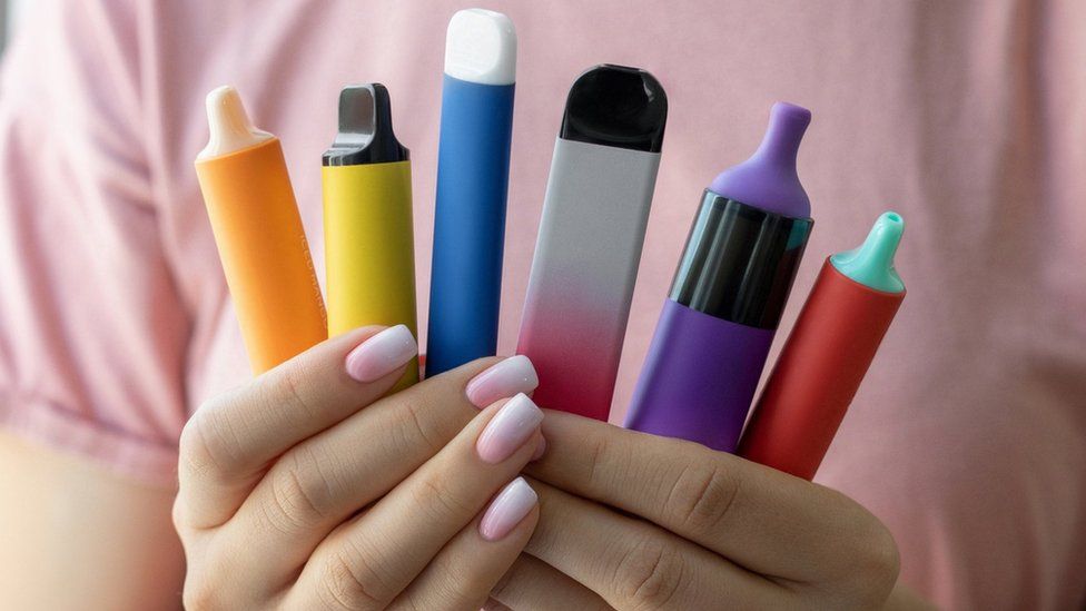 File image showing vapes in a young woman's hand