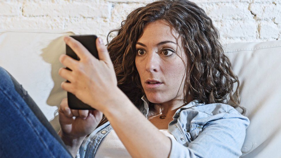 Woman reading content on smartphone