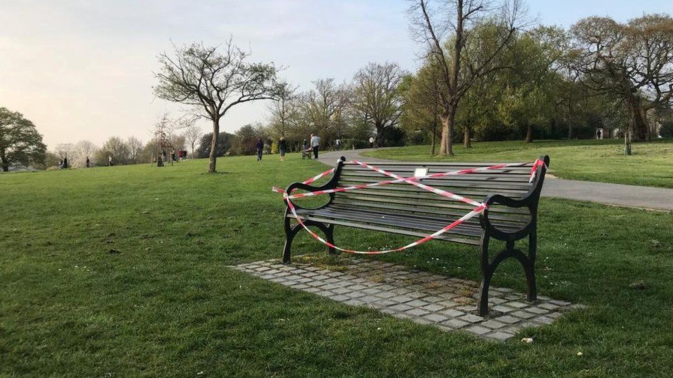 Public benches are taped off in Brockwell Park as the spread of the coronavirus disease (COVID-19) continues, London