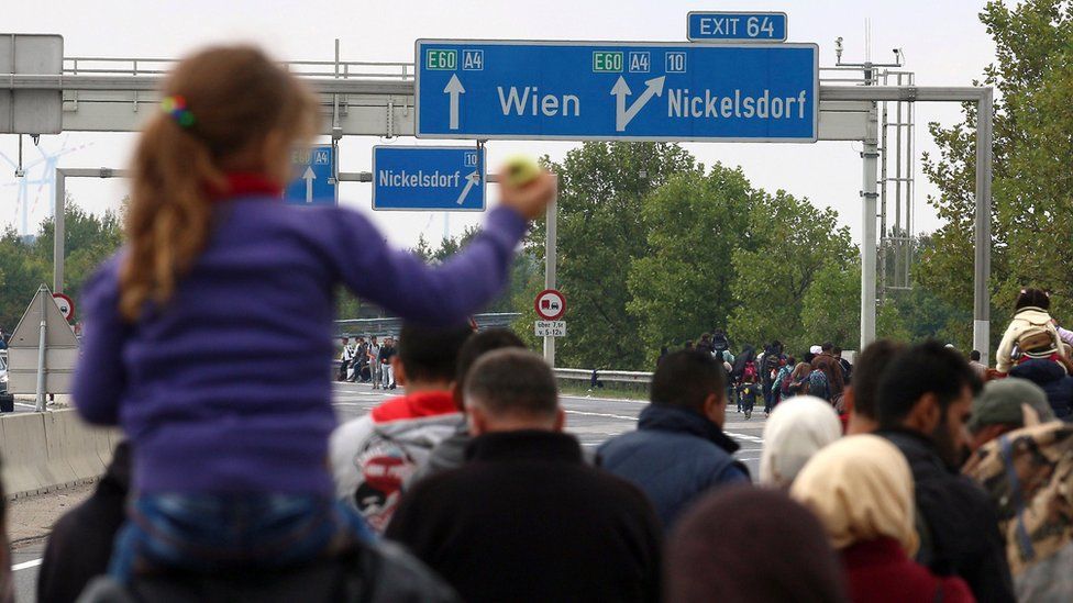 Migrants walk on the highway A4 toward Vienna near Nickelsdorf, Austria, on 11 September 2015