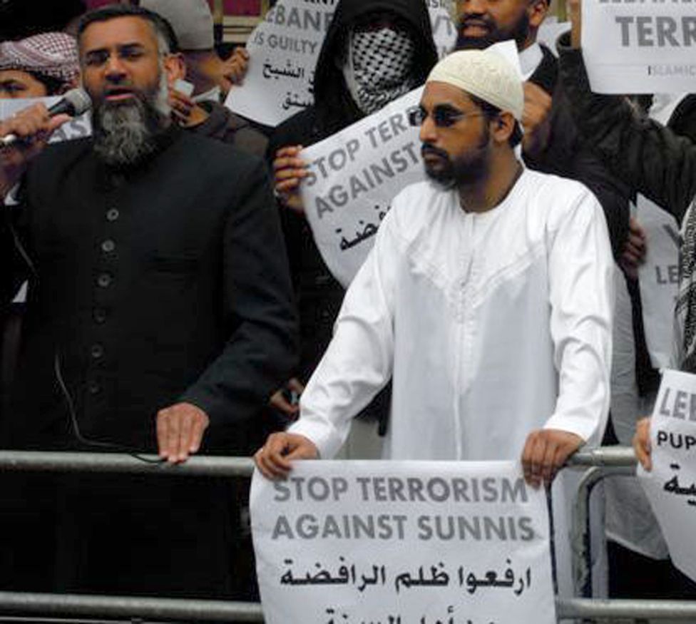 Anjem Choudary with Mohammed Mizanur Rahman at a protest, holding banners sloganed - stop terrorism against sunnis