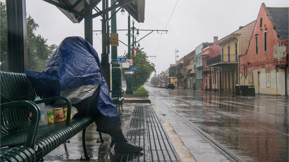 Person waiting at a train stop in New Orleans ahead of Hurricane Ida (29 August)