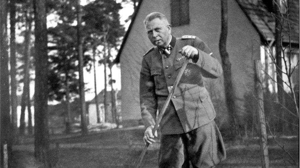 Man in Nazi uniform gardening
