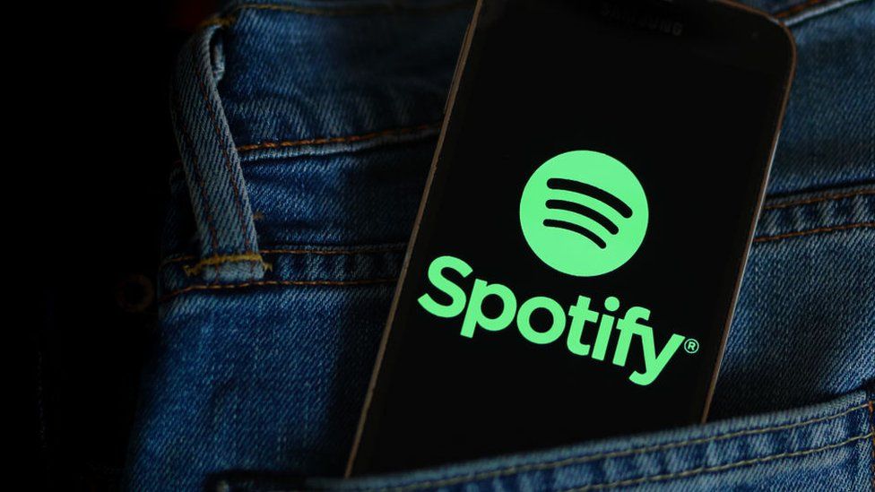 Spotify logo on a phone in a pocket