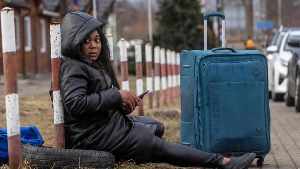 An African woman is seen resting at the Medyka pedestrian border in eastern Poland on February 27, 2022