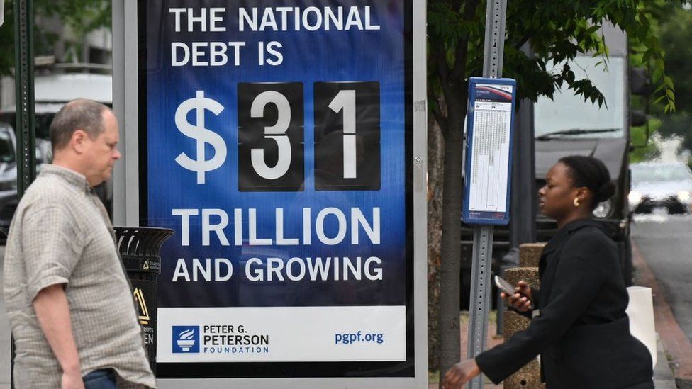 An advertising board showing the US national debt standing at $31tn.