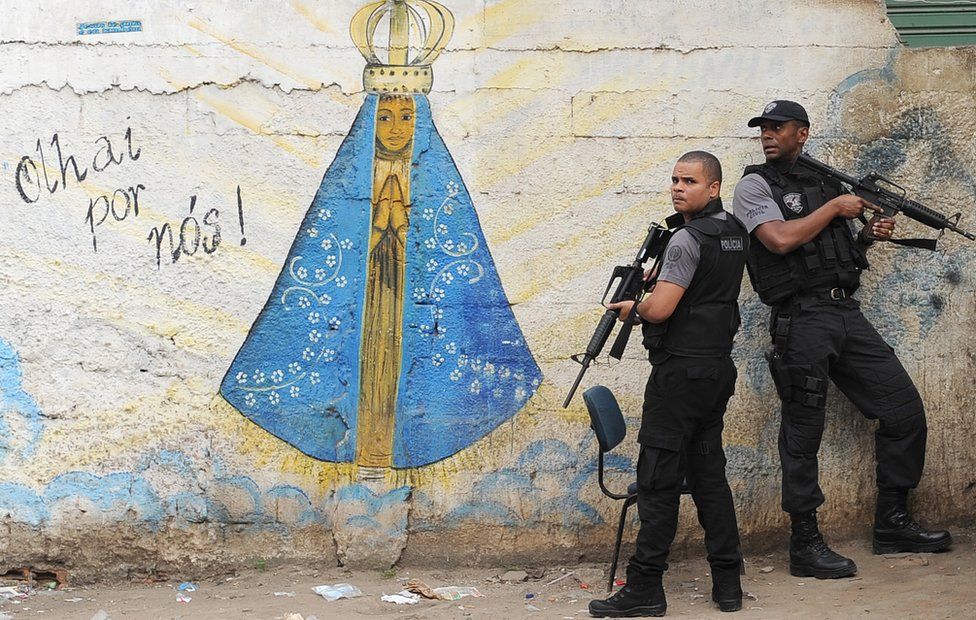 Policemen are pictured during an operation against drug dealers in Jacarezinho slum in Rio de Janeiro on 19 July, 2011