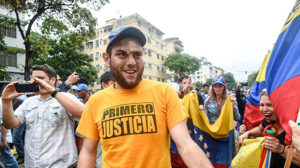 Juan Requesens greets supporters during a protest against the government of Nicolas Maduro in Caracas on April 13, 2017.