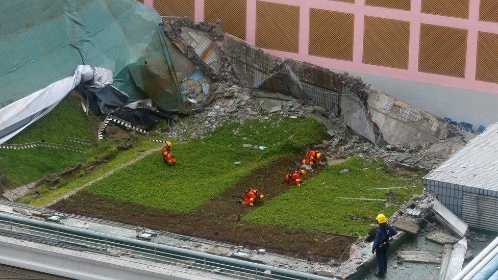 Rescuers search for casualties after the 900-square-metre grass-covered roof of an indoor hall at a City University sports centre collapsed in Hong Kong