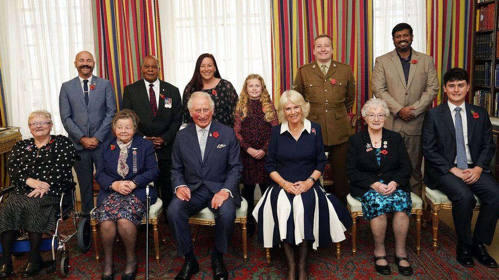 The Prince of Wales (front centre) and Duchess of Cornwall (third right front), with ten Royal British Legion (RBL) Poppy Appeal collectors: (front row left-right) Lesleyanne Gardner, Jill Gladwell, Vera Parnaby, Billy Wilde, and (back row left-right) David Kelsey, Andy Owens, Anne-Marie Cobley, Maisie Mead, Lance Corporal Ashley Martin and Mirza Shahzad