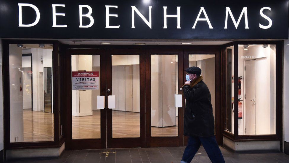 Man walks by closed Debenhams shop