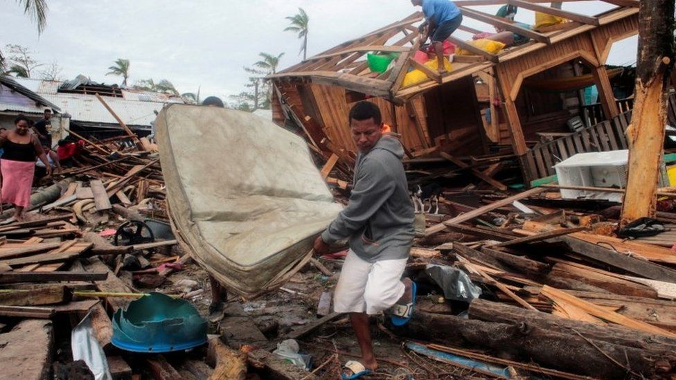 Residents recover a mattress from the debris of their house in Puerto Cabezas, Nicaragua