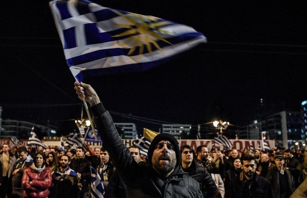 Protesters demonstrate outside the Greek Parliament