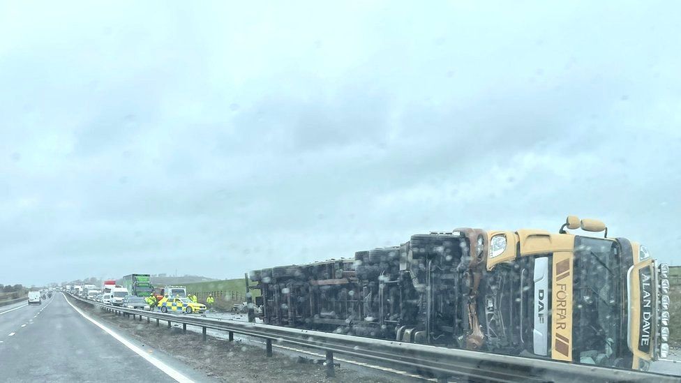 M74 closed after lorry overturns BBC News