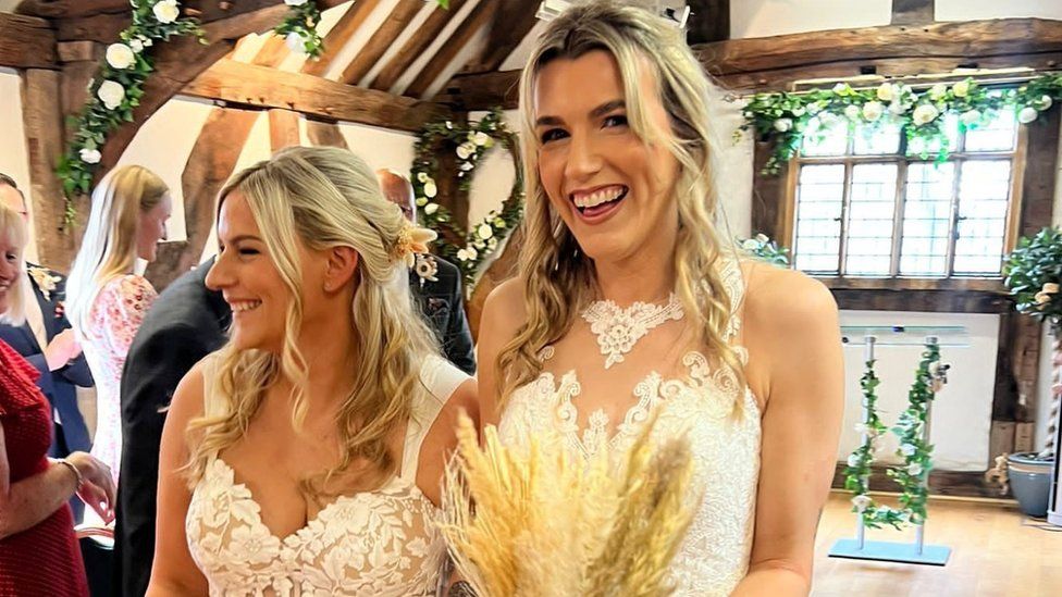 Jemma and Sian Batchelor-Thomas walking down the aisle together