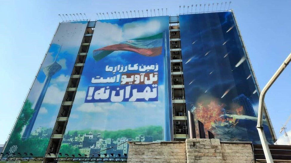 "Tel Aviv is our battleground not Tehran," says a propaganda billboard in the Iranian capital